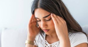 Woman having headache or dizziness problem. Health care and treatment concept. Portrait of a caucasian woman with headache. Health And Pain. Stressed Exhausted Young Woman Having Strong Tension Headache.