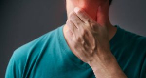 Unhappy Asian man using his hand touching on his neck Suffering From Gland Inflammation. Adult man feels bad on a sore throat and sick from cold, flu. Throat pain, sickness, healthcare, and medical concept.